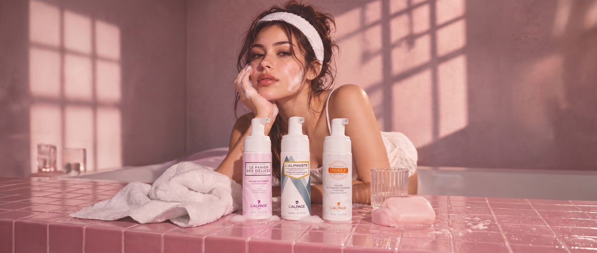 Femme appliquant une mousse nettoyante sur son visage, avec les mousses L'Alpage Le Panier des Délices, L'Alpiniste et Inalp